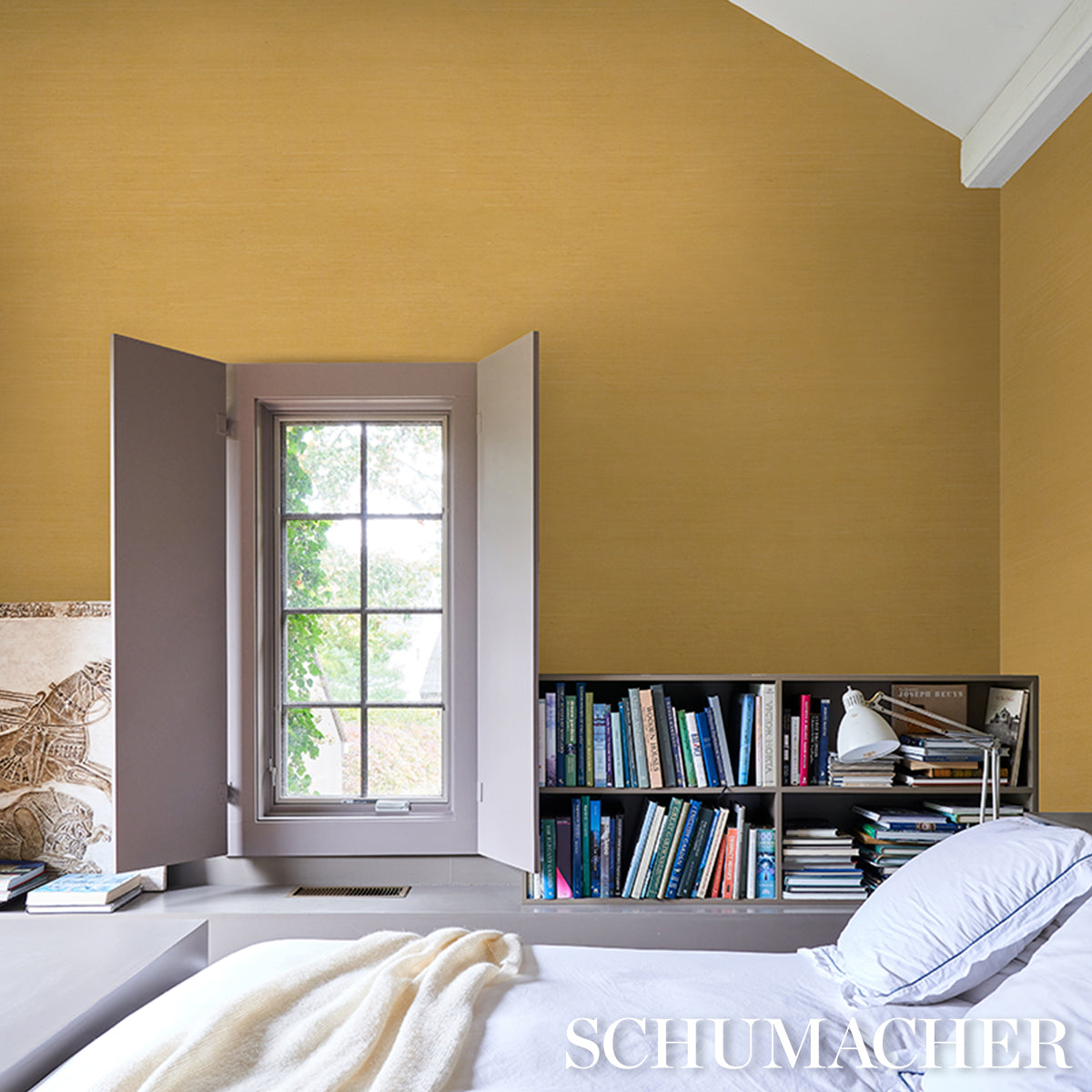 Backdrop depicting a yellow bedroom scene with a white-framed window, a gray bookcase filled with colorful books, and a bed with a pale blue pillow and cream throw.