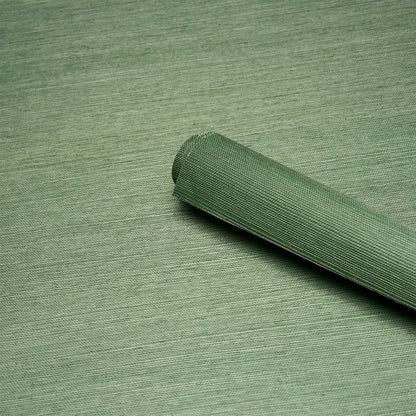Olive green woven fabric roll with curled edge on a matching surface; versatile upholstery or craft textile.