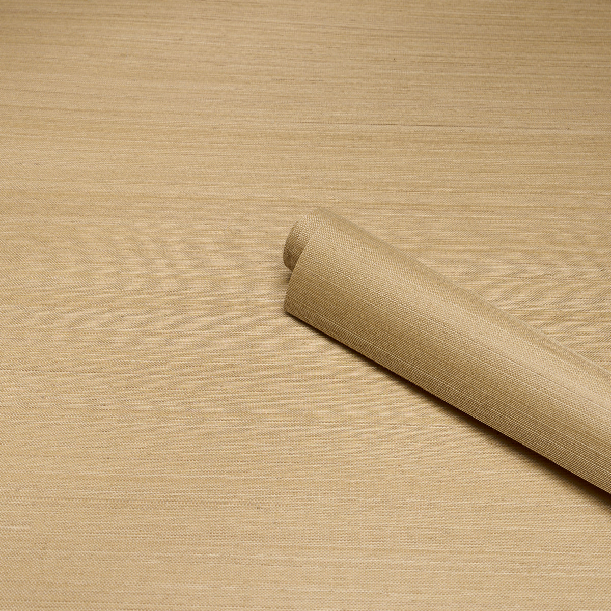 Beige kraft paper roll on light wood surface, diagonally placed for packaging or craft wrapping.