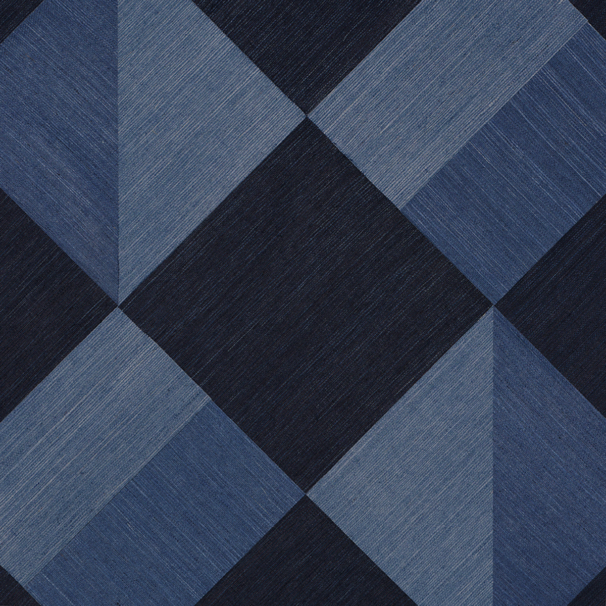Blue denim-toned quilt fabric with large diamond pattern in navy and light blue hues, textured.