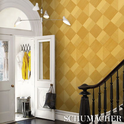 Yellow geometric wallpaper foyer with arched door, open entry, yellow jacket, black stair banister, modern light.