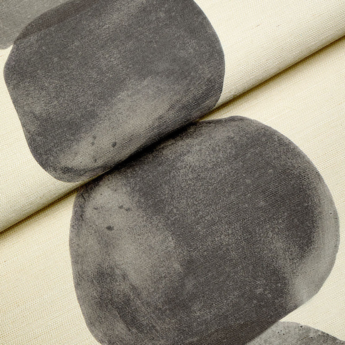 Beige fabric with bold charcoal gray circular shapes; abstract geometric print for upholstery, cushions or drapery.
