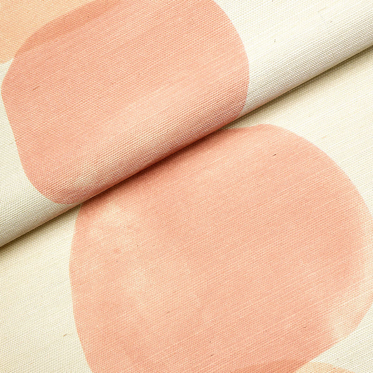 Beige fabric with large peach circles in an abstract dot pattern; woven texture, rolled edge.