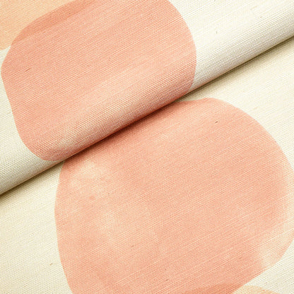 Beige fabric with large peach circles in an abstract dot pattern; woven texture, rolled edge.