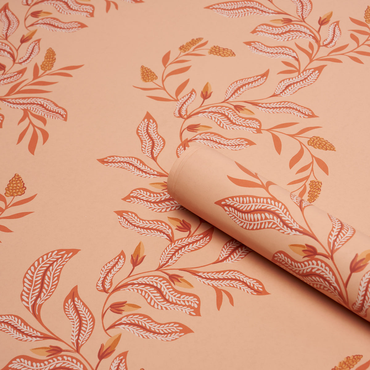 Peach wallpaper with orange botanical leaf pattern; rolled edge reveals seamless leaf design.