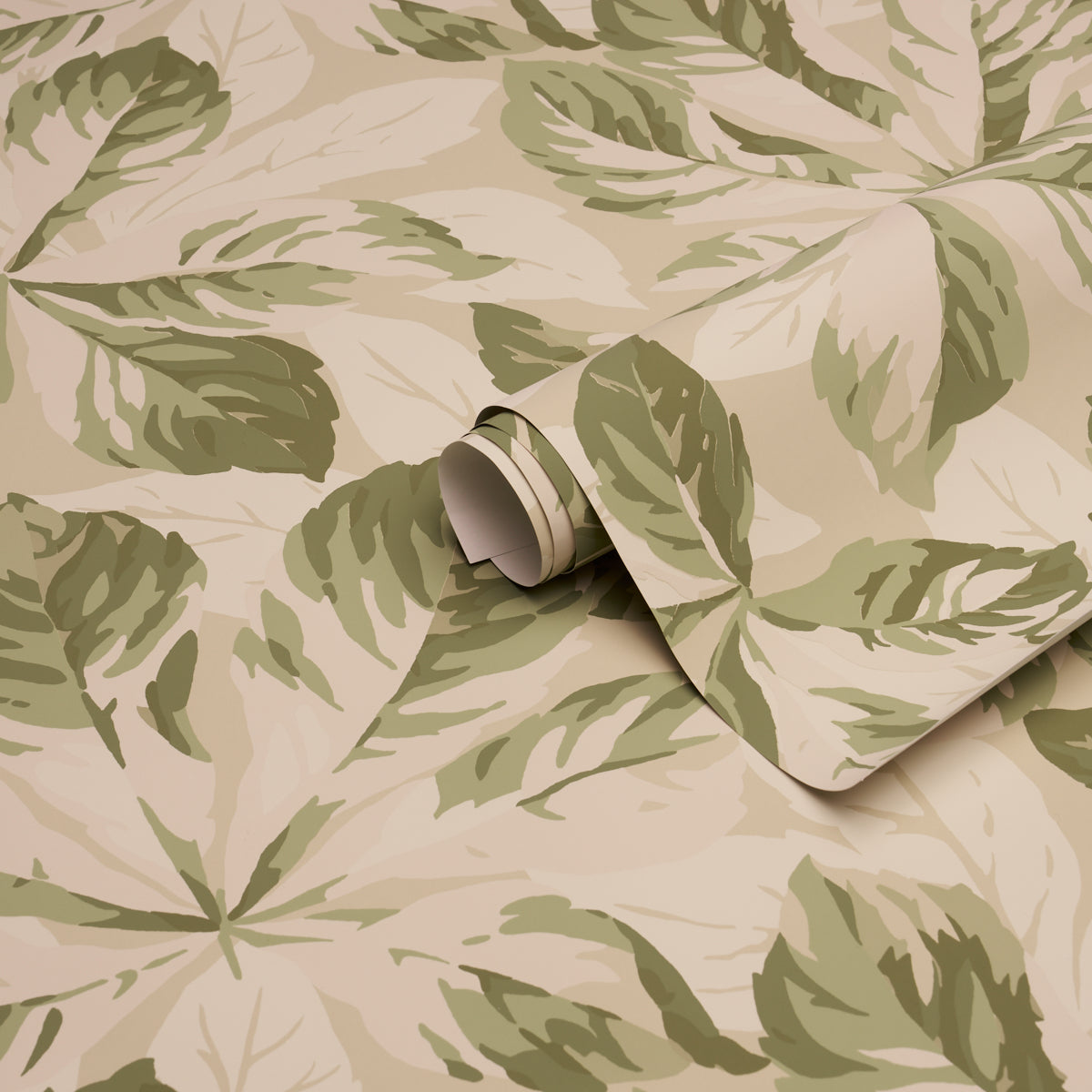 Beige wallpaper with large sage and olive tropical leaves; rolled corner reveals classic wallcovering.