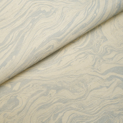 Beige fabric with pale blue marble-like swirl pattern and soft textile texture.