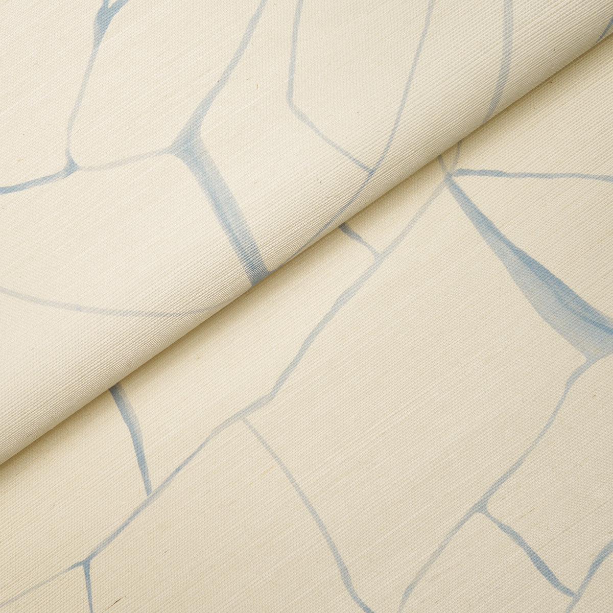 Beige fabric with pale blue crackle lines, rolled fold; subtle marble-like pattern for upholstery or drapery.