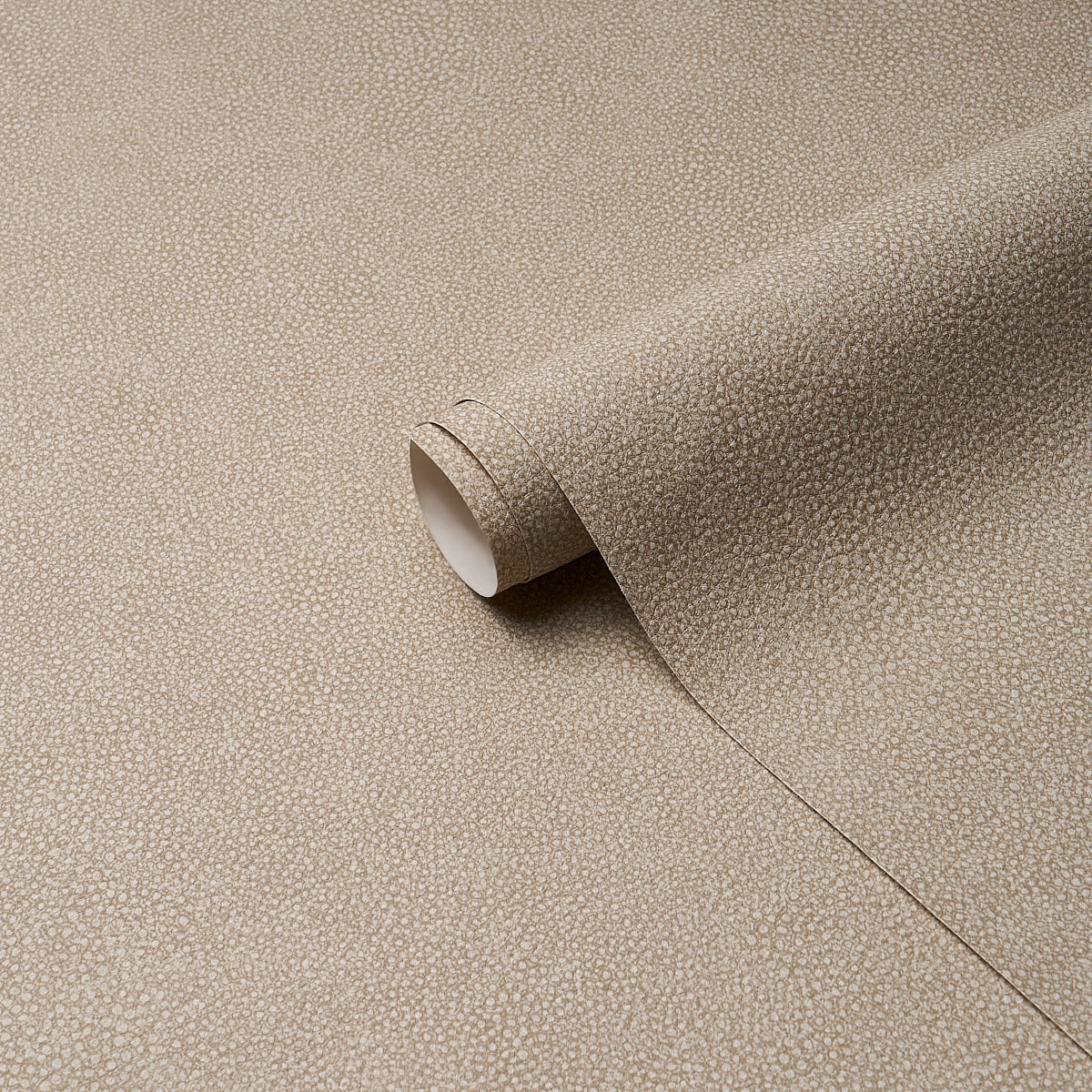 Beige stone-textured vinyl sheet with shagreen pattern, curved to reveal white backing.