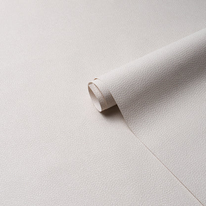 Beige pebbled leather sheet rolled at the edge, textured upholstery leather suitable for crafts.