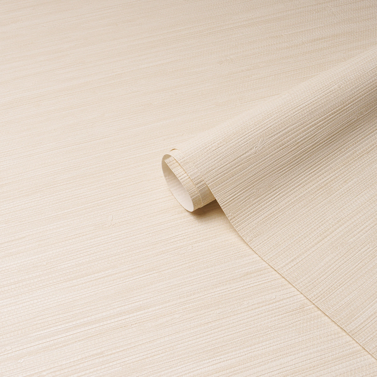 Beige textured wallpaper roll with linen-like grain on cream surface, for walls.