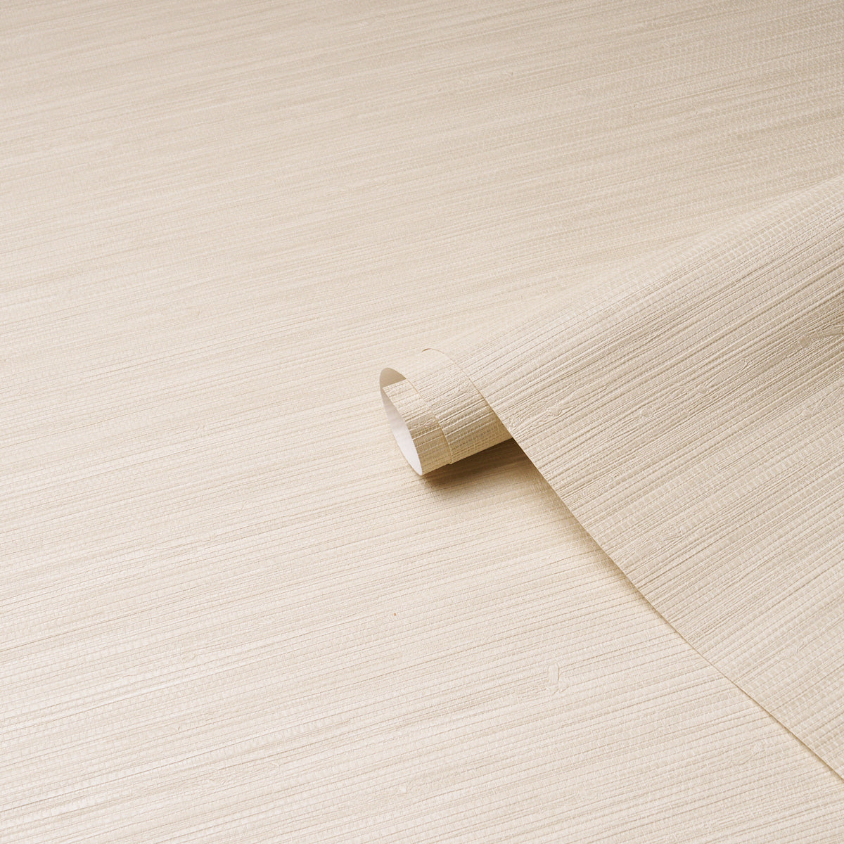 Beige wood veneer sheet with subtle grain, curling edge; light laminate for furniture or wall paneling.