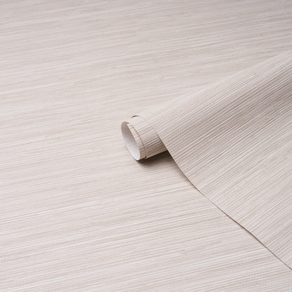 Beige wood-grain wallpaper roll, curled edge, partially unrolled on a light wooden surface.