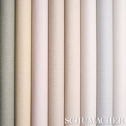 Row of vinyl sample rolls with a linen-textured surface in soft neutral pastels and creams, from green to grey.