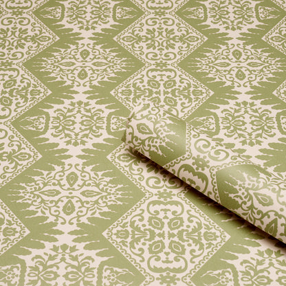 Olive green and cream damask wallpaper with repeating diamonds; rolled corner shows subtle texture.