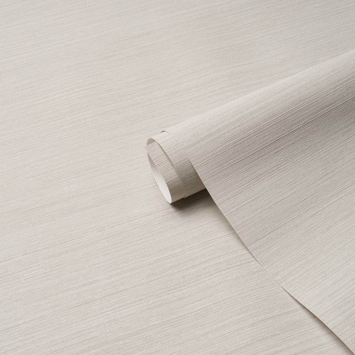 Pale dove gray vinyl wallpaper roll with abaca fine-weave texture, partially unrolled.