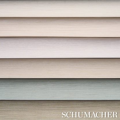 Stack of dove-colored vinyl wallpaper samples with fine weave texture.