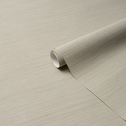 Beige textured wallpaper roll with linen-like grain, partially unrolled for wall decor.