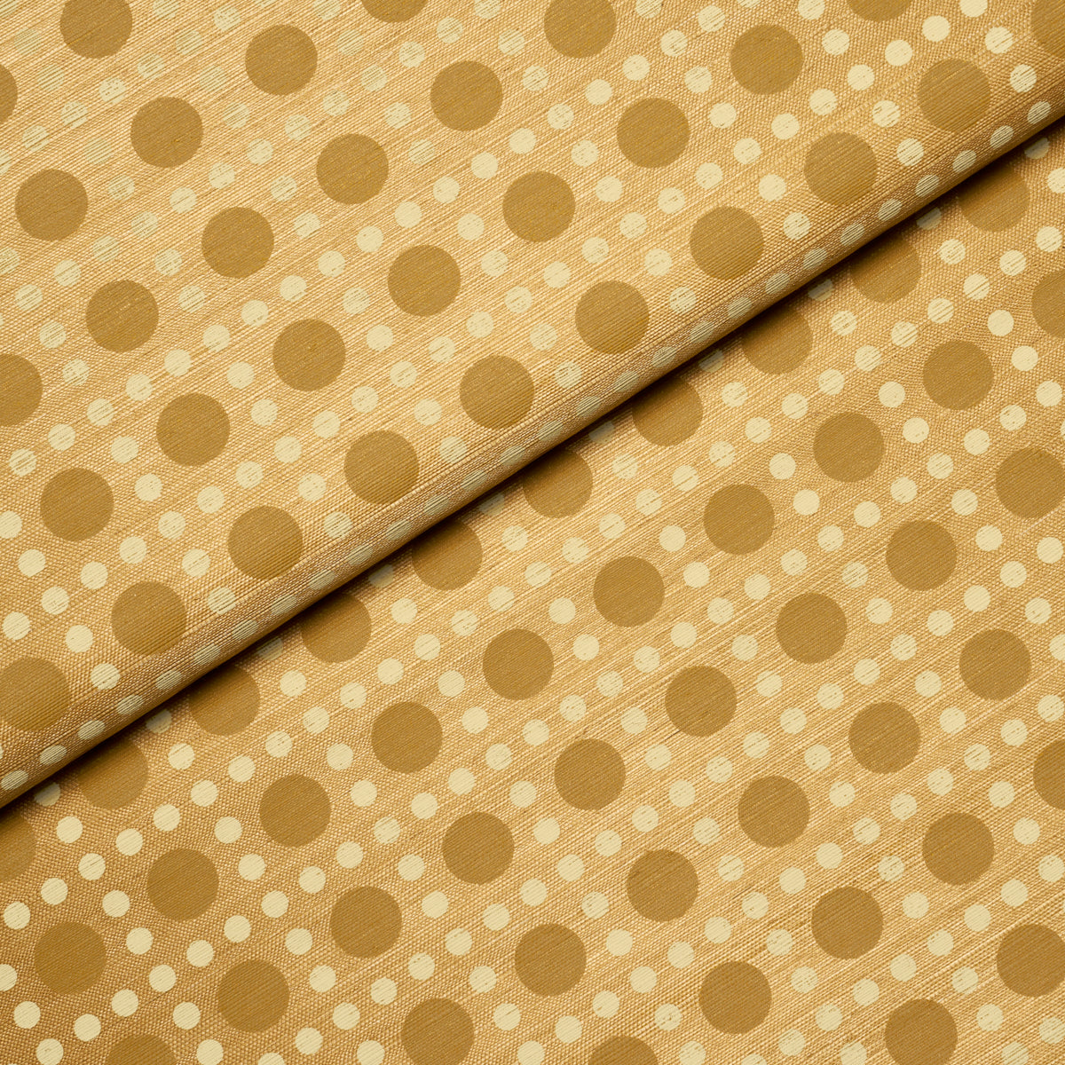 Gold-beige fabric with a small brown-dot pattern; soft, drapable textile for upholstery or crafts.