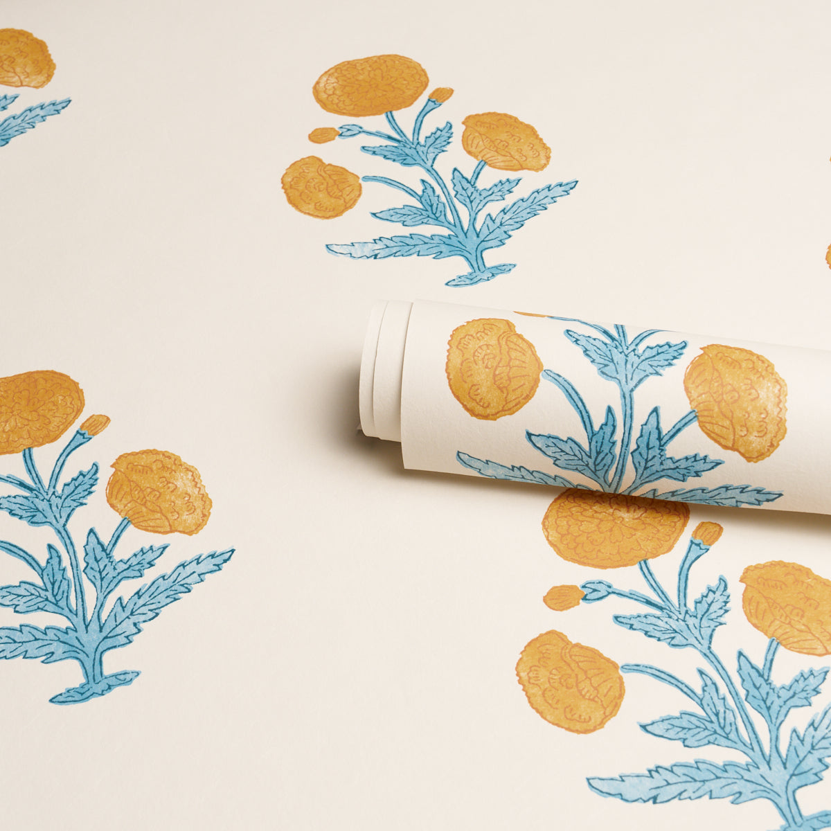 Decorative wallpaper roll with a poppy print in mustard and sky on a cream background.