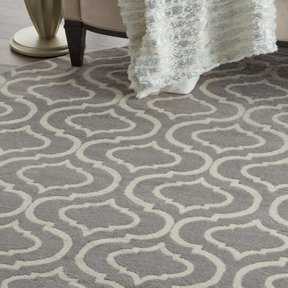 Gray & cream trellis-pattern round area rug with soft pile in a living room setting