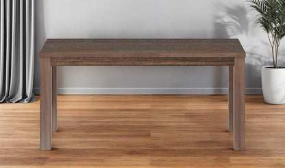 Rectangular wooden dining table with dark textured top and lighter brown chunky legs, modern minimalist style.