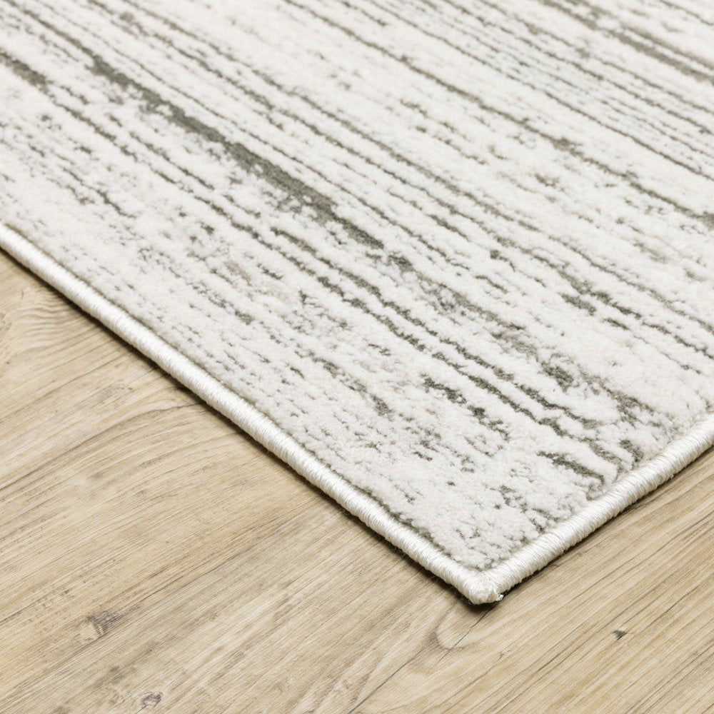 5' x 8' white and grey abstract power loom stain resistant area rug