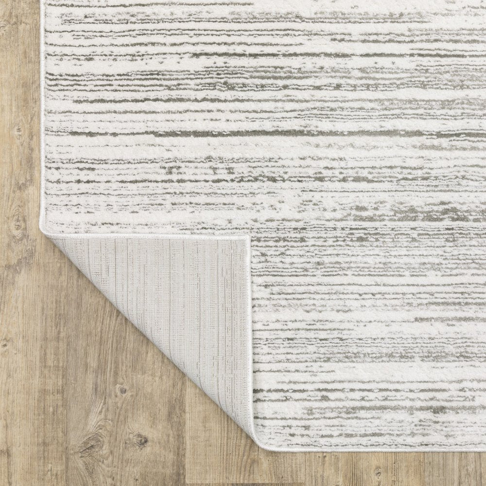 5' x 8' white and grey abstract power loom stain resistant area rug