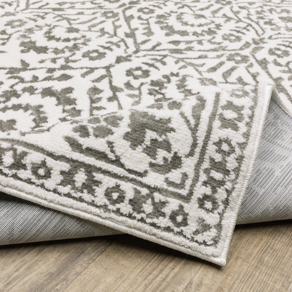 7' X 10' Gray And White Floral Distressed Area Rug