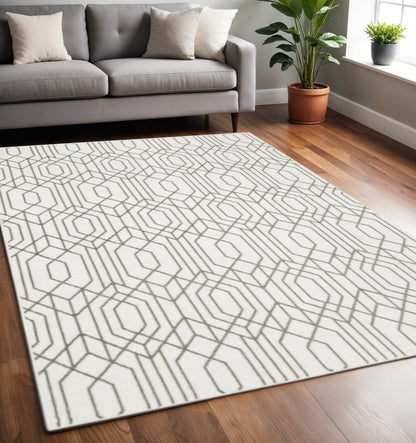 White and grey geometric power loom area rug, 5' x 8', stain resistant.