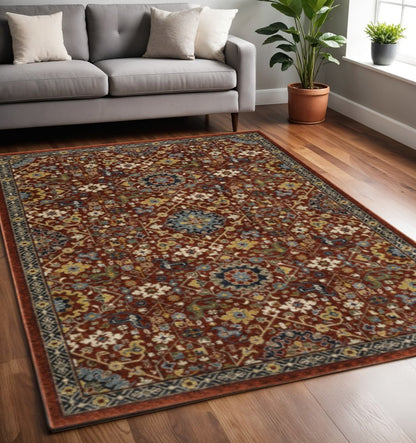 5' X 8' Red Blue Gold And Ivory Oriental Power Loom Stain Resistant Area Rug With Fringe
