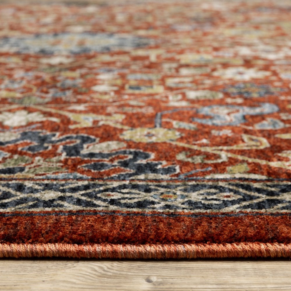 5' X 8' Red Blue Gold And Ivory Oriental Power Loom Stain Resistant Area Rug With Fringe