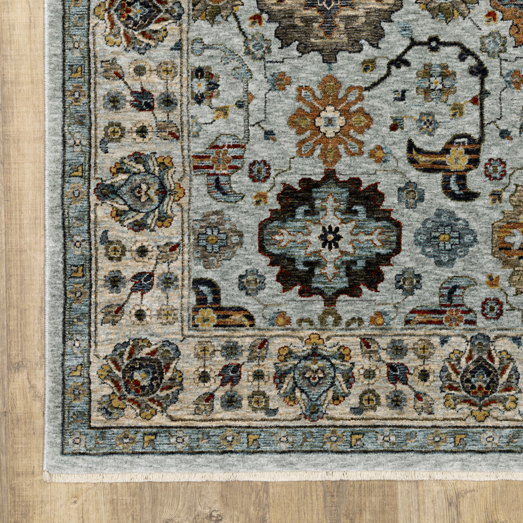 6' X 9' Blue Beige Grey Green Yellow And Rust Oriental Power Loom Stain Resistant Area Rug With Fringe