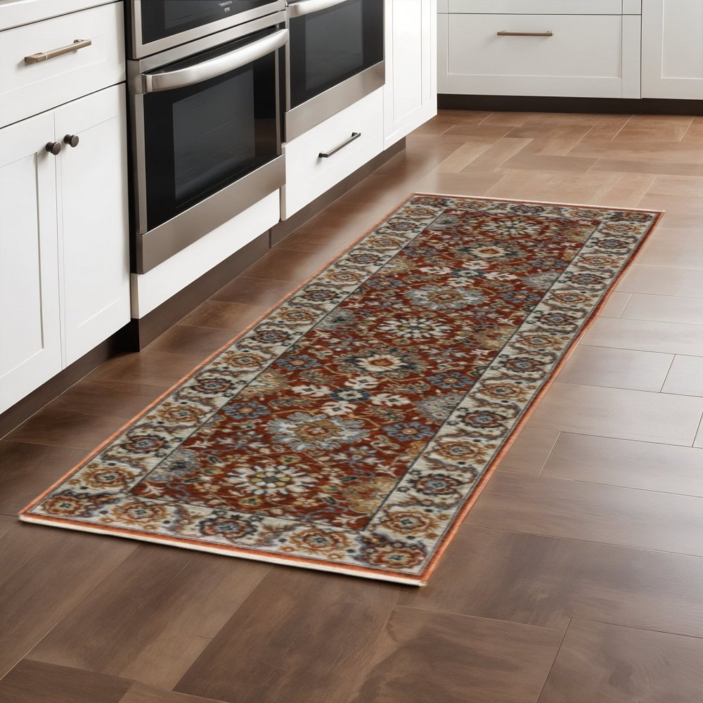 2' X 8' Red Blue Ivory Gold And Navy Oriental Power Loom Stain Resistant Runner Rug With Fringe