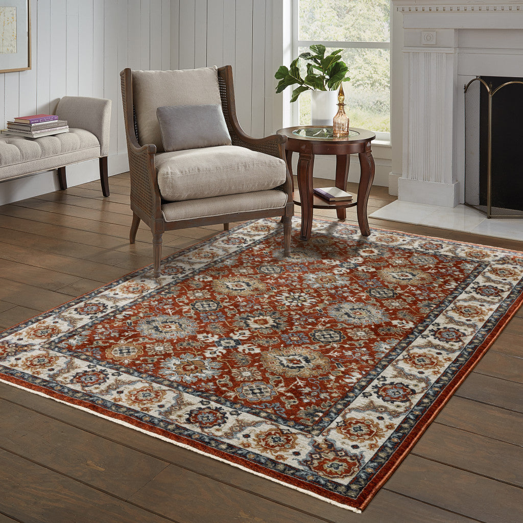 10' X 13' Red Blue Ivory Gold And Navy Oriental Power Loom Stain Resistant Area Rug With Fringe