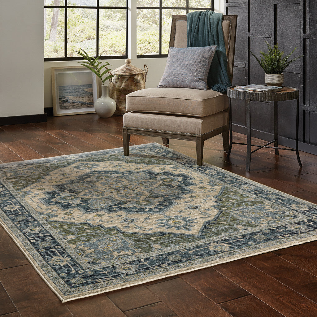 5' X 8' Blue Grey Beige Tan Green And Gold Oriental Power Loom Stain Resistant Area Rug With Fringe