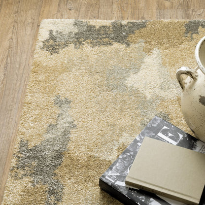 5' X 8' Beige Grey And Gold Abstract Power Loom Stain Resistant Area Rug