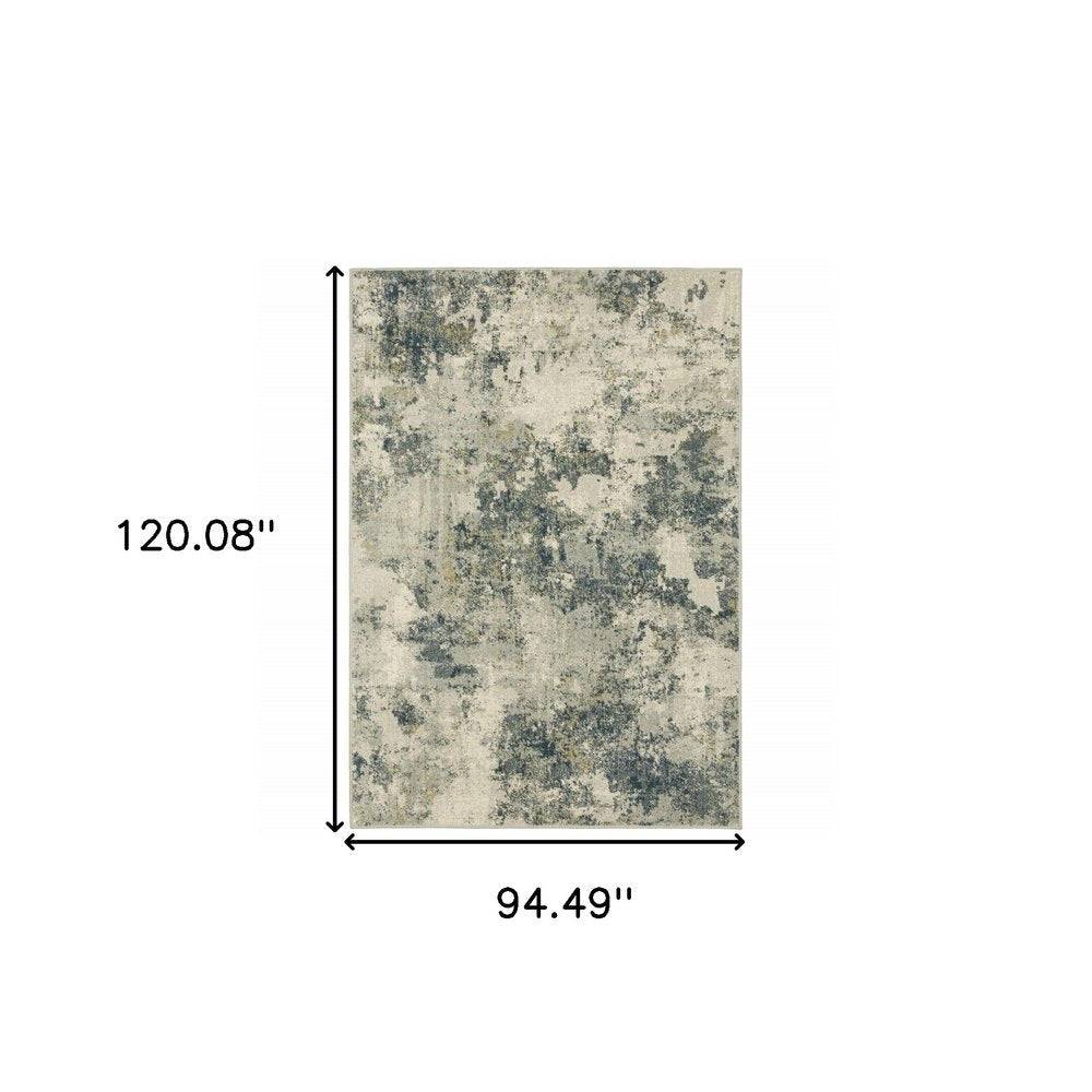 Rectangular area rug with abstract cream, gray & navy pattern, 120.08" long by 94.49" wide.