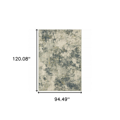 Rectangular area rug with abstract cream, gray & navy pattern, 120.08" long by 94.49" wide.