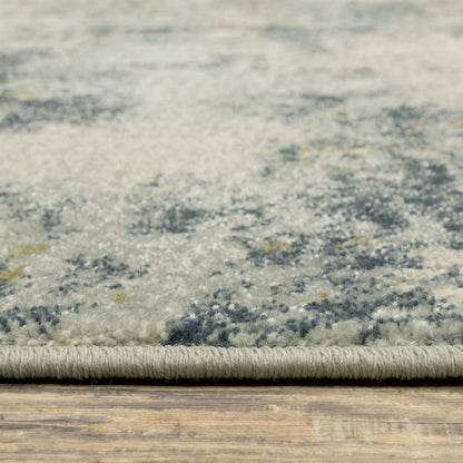 8' x 10' beige, teal, grey and gold abstract area rug on a wooden floor