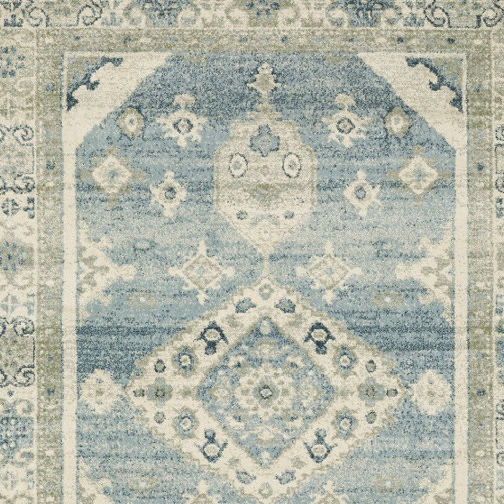 Blue and beige oriental area rug with ivory diamond medallions, distressed vintage pattern, rectangular.