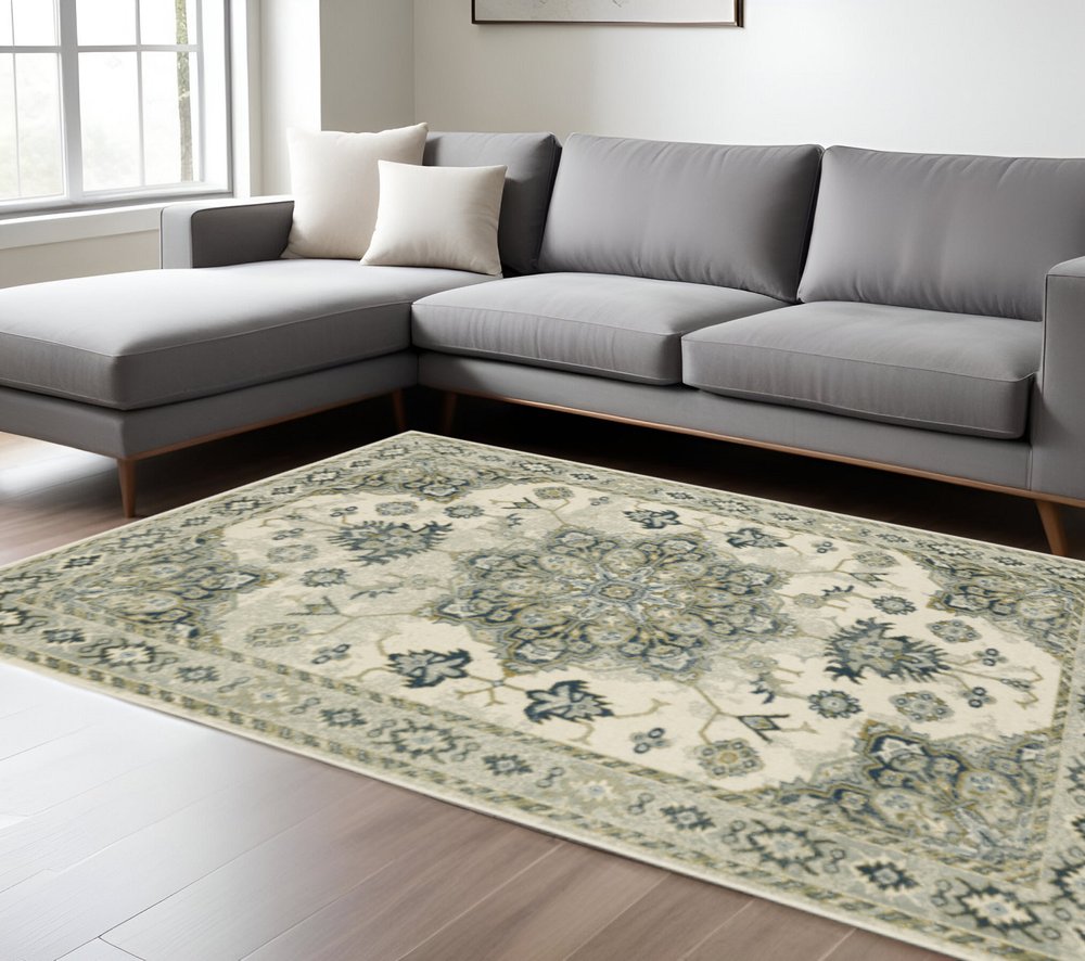 10' X 13' Ivory Blue Teal Grey And Olive Green Oriental Power Loom Stain Resistant Area Rug