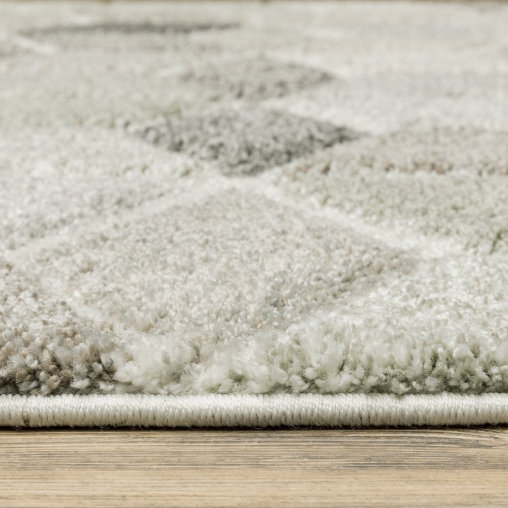 2' x 8' runner rug with beige, brown, grey, tan, sage and pale blue geometric pattern; power loom construction; stain resistant.