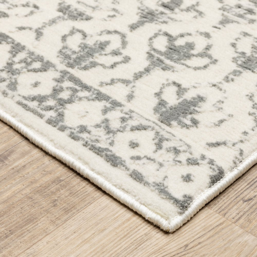 10' x 13' ivory and grey floral power loom area rug; stain resistant.