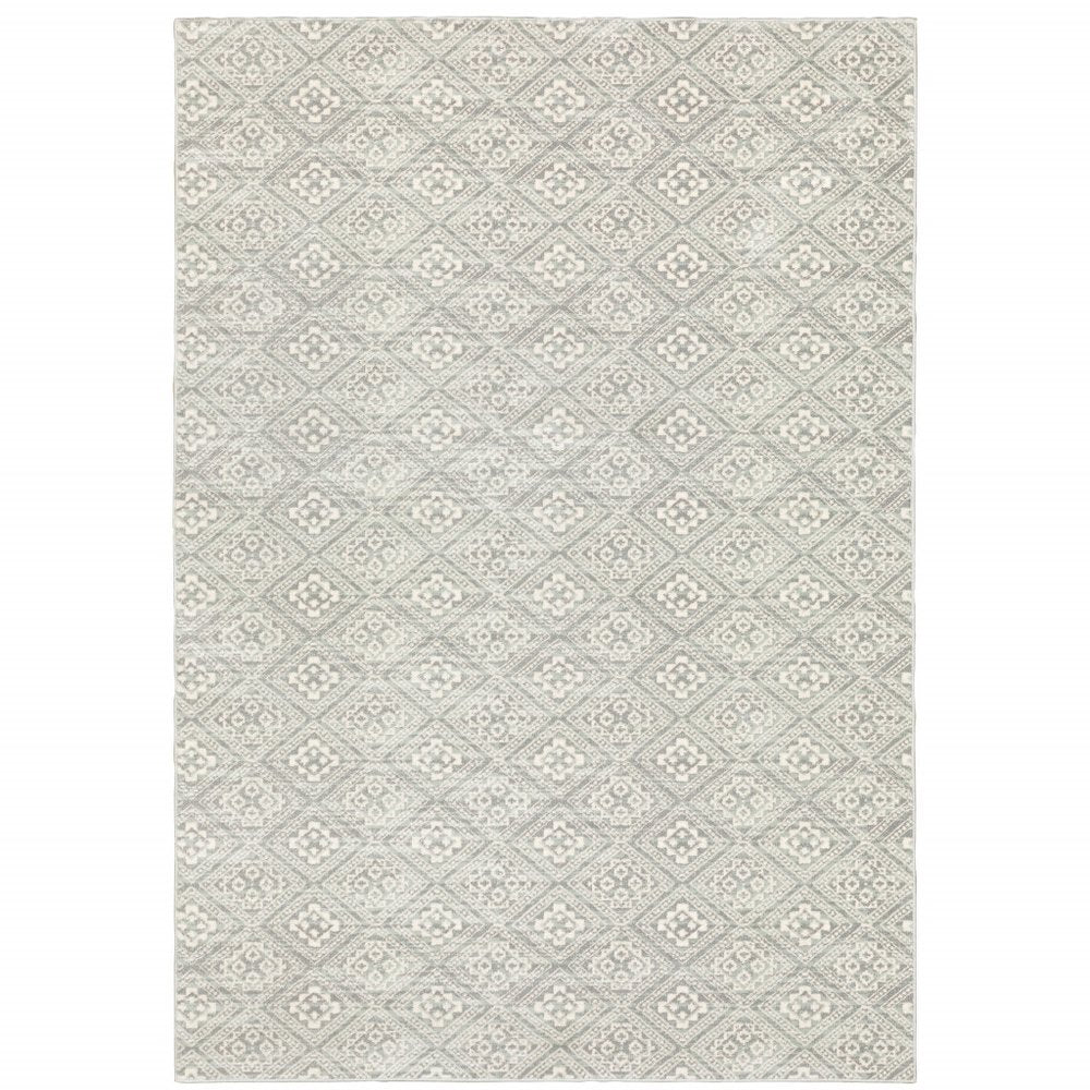 Grey geometric area rug with repeating diamond lattice pattern in light ivory; soft woven texture.