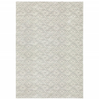 Grey geometric area rug with repeating diamond lattice pattern in light ivory; soft woven texture.