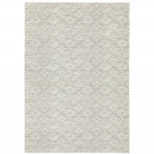 Grey geometric area rug with repeating diamond lattice pattern in light ivory; soft woven texture.