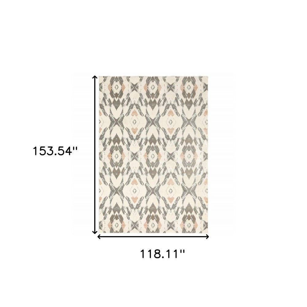 Rectangular area rug with geometric pattern in ivory, pink and sage; approx 118x154 inches