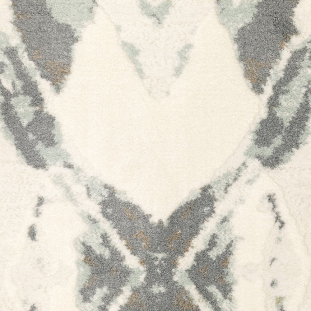 Ivory pink and sage geometric area rug with a diamond pattern; power-loom construction; stain resistant.