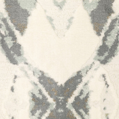 Ivory pink and sage geometric area rug with a diamond pattern; power-loom construction; stain resistant.